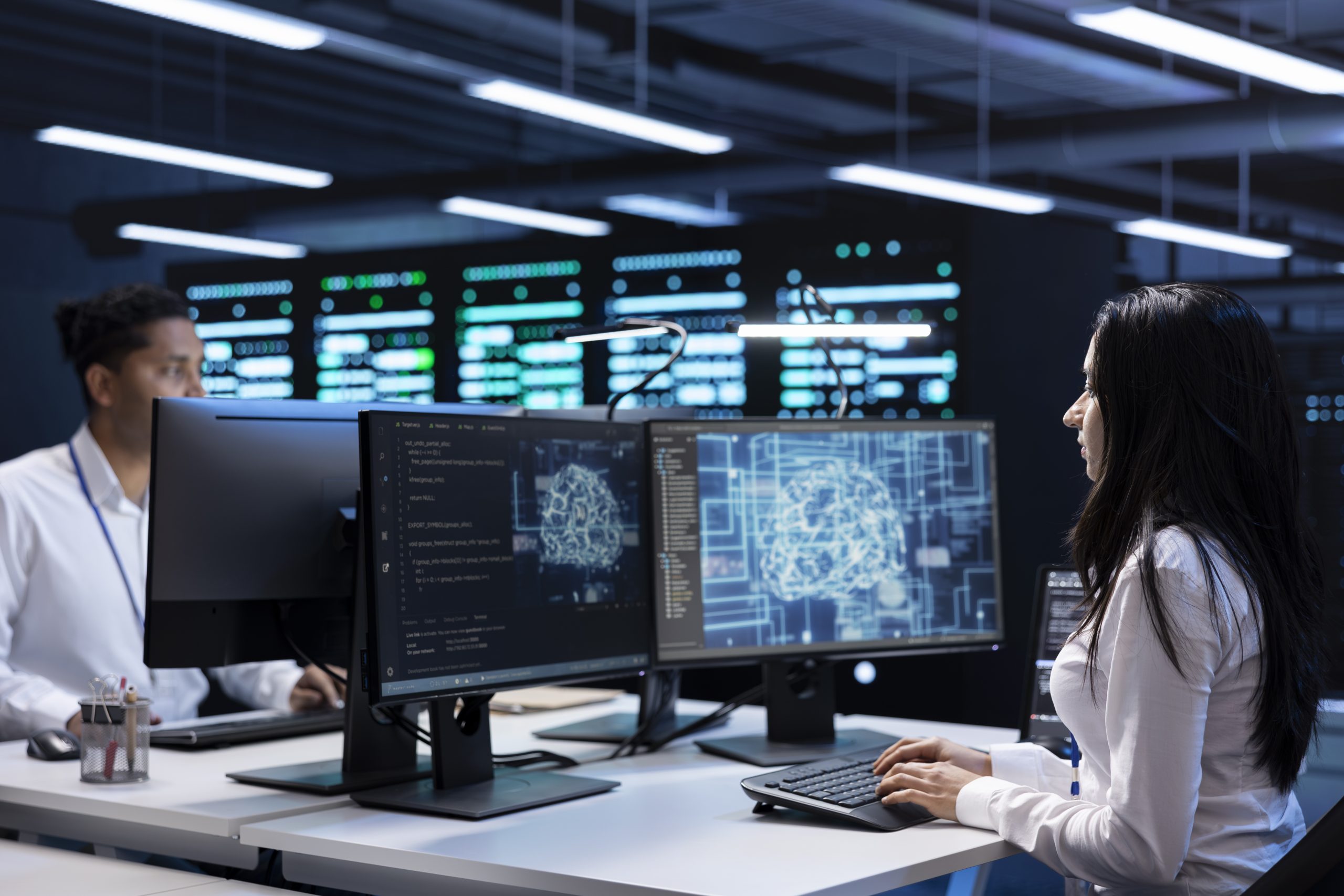Team of specialists working on PC in data center with artificial intelligence tech to process massive datasets. Engineering colleagues solving tasks in server hub storing data used for deep learning
